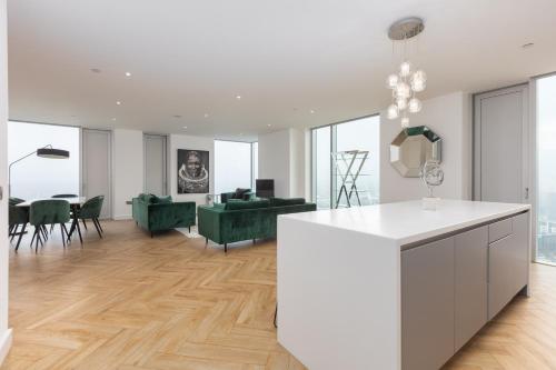 a kitchen and living room with white walls and wood floors at Greengate in Manchester