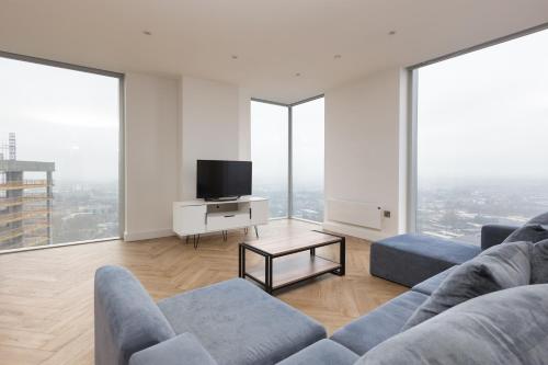 a living room with a couch and a tv at Greengate in Manchester