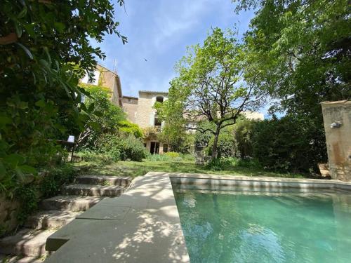 une piscine devant une maison dans l'établissement Luberon en Provence - La maison de Michèle au cœur de Goult, à Goult