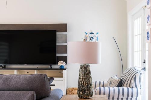 a living room with a couch and a lamp at Delray Oasis: Pool, Gazebo & Beach Access in Delray Beach