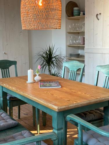 a wooden table with chairs and a lamp at Altstadt-Gästehaus mit Garten. Und Herz. in Bad Kreuznach