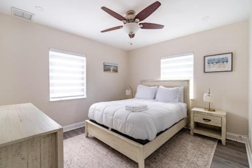 a bedroom with a bed with a ceiling fan at Delray Oasis: Pool, Gazebo & Beach Access in Delray Beach