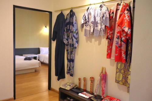 a room with a mirror and clothes hanging on a wall at Morimei Khaoyai in Ban Khlong Yang