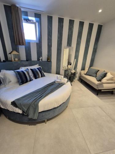 a large bedroom with a large bed and a couch at La Maison de Rosaline Rooms in Barletta