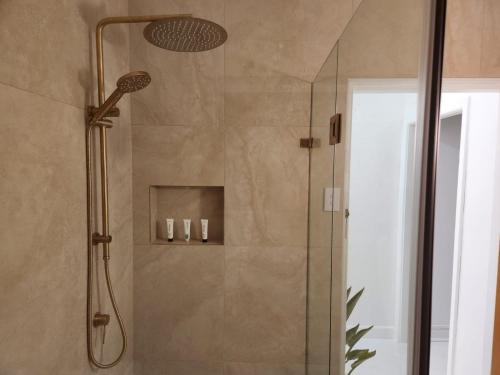 La salle de bains est pourvue d'une douche avec un pommeau de douche. dans l'établissement Beach shack!, à Sydney