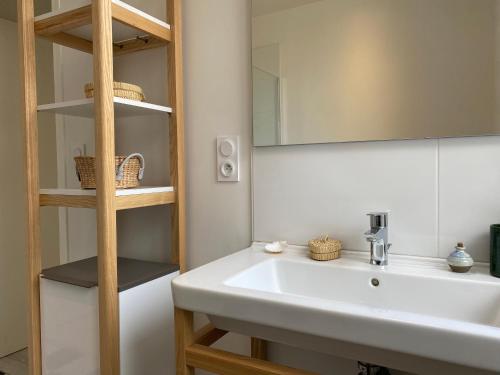 a bathroom with a white sink and a mirror at 1009 - Maison du Val-André située à quelques pas de l'îlot du Verdelet et de la plage in Pléneuf-Val-André