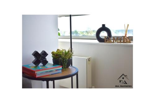 a table with books and a plant on it in a kitchen at Fully Furnished 2 Bed 2 Bath City Centre Luxury Apartment - Free Parking - Pets are Allowed in Bracknell