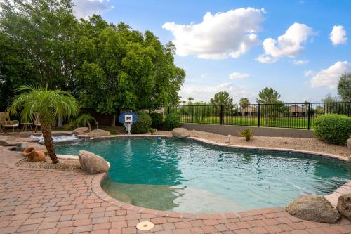 a swimming pool in a yard with rocks and trees at Expansive Mesa Retreat with Private Outdoor Pool! in Mesa