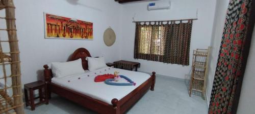 a bedroom with a bed with a cake on it at Santa Rita lodge in Kiwengwa
