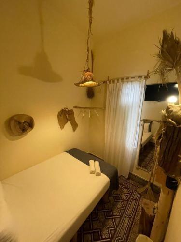 a bedroom with a white bed and a window at Cactus Host in Las Palmas de Gran Canaria