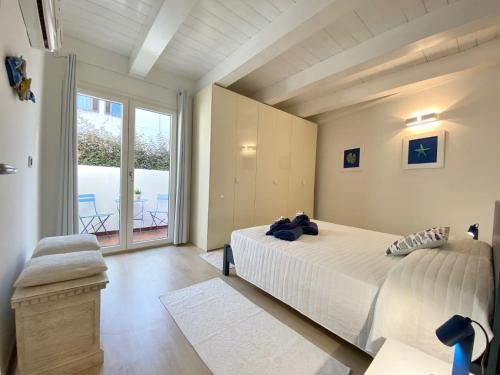a bedroom with a bed and a large window at Guendalina in Santa Teresa Gallura