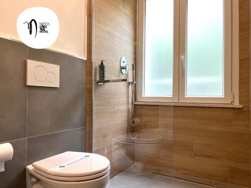 a bathroom with a toilet and a shower at Hotel Nizza Creative Hotel in Rimini