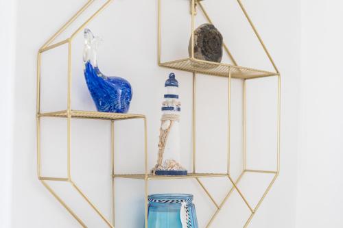 a gold and glass shelf with vases and a mirror at Host & Stay - Abbey View in Whitby