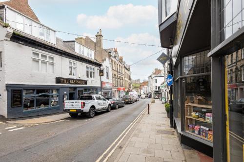 a street with cars parked on the side of the road at Host & Stay - Abbey View in Whitby