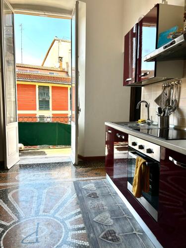 a kitchen with a stove and an open door at La bella vista in Sestri Levante
