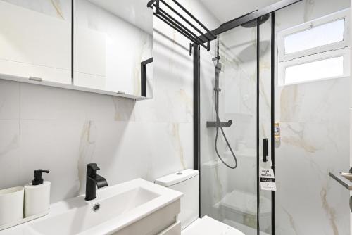a bathroom with a sink and a shower at Largo da Estação Apartments By Sé Apartamentos in Braga