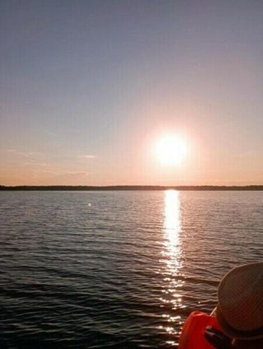 a person on a boat on a large body of water at Номад in Karakol