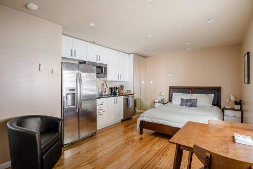 Cet appartement comprend une chambre avec un lit et une cuisine avec une table. dans l'établissement Modern studio within easy reach of Tech Giants, à East Palo Alto