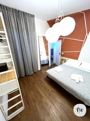 a bedroom with a bed and a book shelf at Hotel Nizza Creative Hotel in Rimini