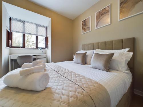 a bedroom with a large white bed with two pillows at Cosy Modern Apartment Colchester in Colchester