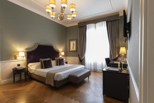 Postel nebo postele na pokoji v ubytování Palazzo Roselli Cecconi