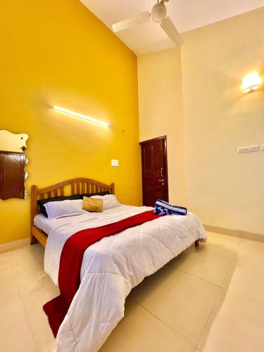 a bedroom with a large bed in a yellow wall at Mount View Villa - The Dream Stays ll Pvt Pool ll Garden ll 3Ac rooms in Lonavala