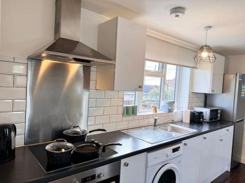 a kitchen with a sink and a stove top oven at Superb Studio in Wembley 30min to Central London in London