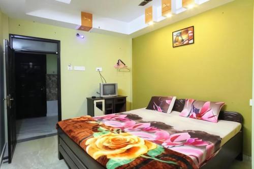 a bedroom with a bed and a television in it at Hotel Parteek Residency Near Amrabati Park - Bypass Road Digha in Digha