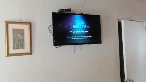 a flat screen tv hanging on a wall at Punta Pacífico Bungalows Máncora in Máncora