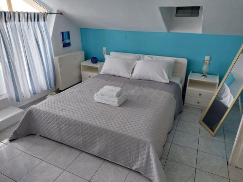 a bedroom with a bed with two towels on it at Kanaliblue in Kanali