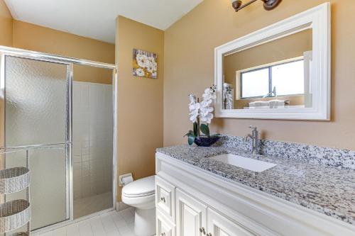 un bagno con un water, un lavandino e uno specchio di Near Beaches Pet-Friendly Sunrise Escape with Patio a Sunrise