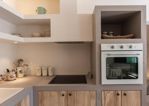a kitchen with a white oven and a sink at Villa Mati in Macchia di Monte