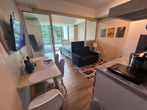 a room with a kitchen and a living room at Azure Staycation in Manila