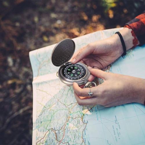 a person holding a compass on a map at Achouffe Valley in Achouffe