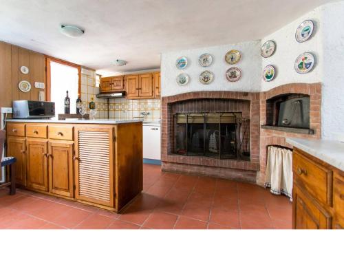uma cozinha com lareira com placas na parede em Villa del Monte di Cocco em Lucca