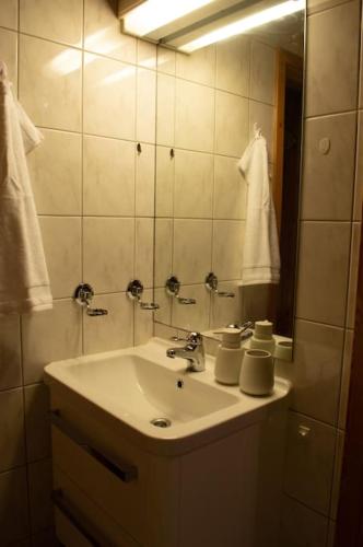 a bathroom with a sink and a mirror at Aurora panorama in Laksvatn