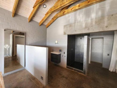 a bathroom with a sink and a mirror in a room at Mustique-Beachfront bliss in St. Helena Bay