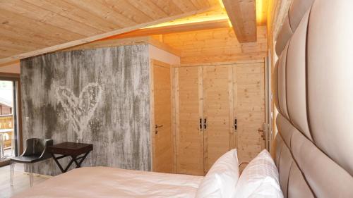 a bedroom with a bed and a sliding door at Caschu Alp Boutique Design Hotel Stoos - adults only in Stoos