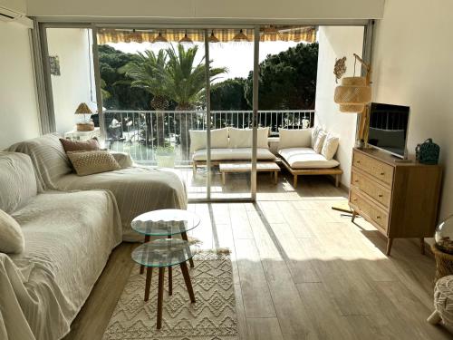 un salon avec un canapé et une table dans l'établissement Cosy studio devant la mer Lavandou, au Lavandou