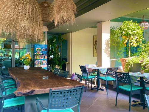 a restaurant with a wooden table and chairs at Hotel Alfieri in Sirmione
