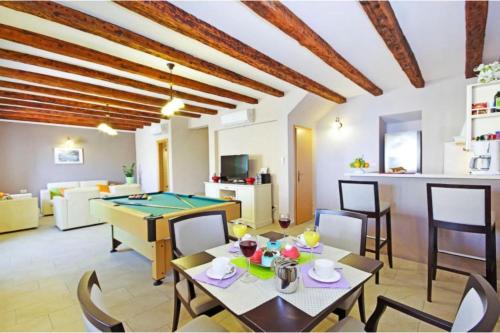 a living room with a ping pong table at Luxury Panorama Villa Dia in Brsečine