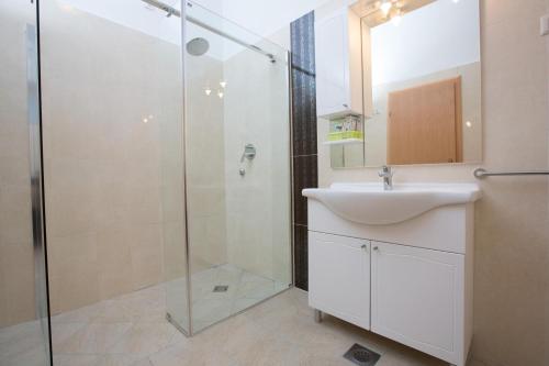 a bathroom with a sink and a shower at Luxury Panorama Villa Dia in Brsečine