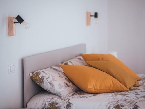a bunch of pillows sitting on a bed at C'era una Volta Apartments in Bisceglie