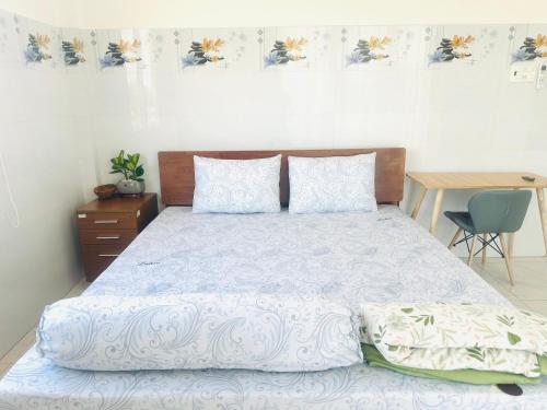 a bedroom with a large bed with a wooden headboard at KimMy Home in Phan Thiet