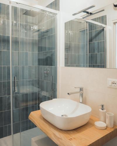 a bathroom with a sink and a shower at C'era una Volta Apartments in Bisceglie