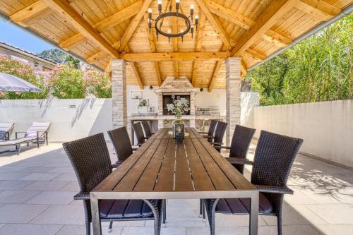 un tavolo da pranzo all'aperto con sedie e un soffitto in legno di Pool House Edita - Happy Rentals a Bribir