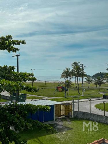 a view of a park with the ocean in the background at Cantinho do Mar Pousada in Bertioga