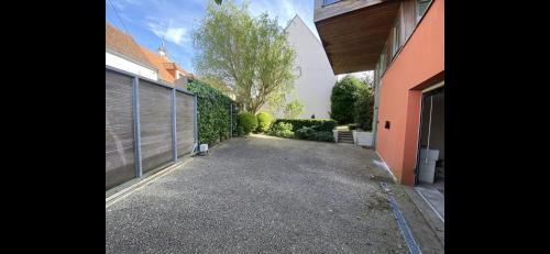 a driveway leading to a house with a garage at B&B - Villa des Remparts - Ardres proche Calais-St Omer-Dunkerque in Ardres