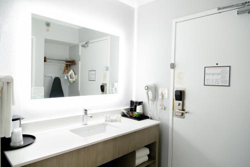 a bathroom with a sink and a mirror at La Quinta Inn Birmingham - Inverness in Birmingham