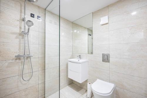 a bathroom with a shower with a toilet and a sink at 1bedroom flat Central London NW6 in London